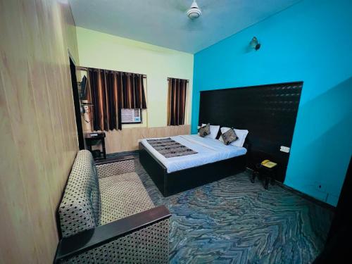 a hotel room with a bed and a blue light at Gaurav Boarding House in Mathura