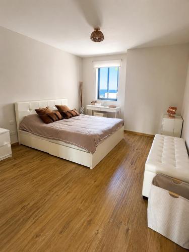 a large bedroom with a large bed and a window at Marsascala St Thomas bay in Marsaskala