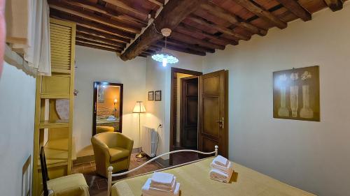 a living room with a table and a chair at Agriturismo la Torre in Bagni di Lucca