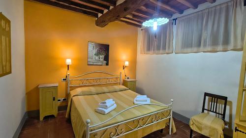 a bedroom with a bed with two towels on it at Agriturismo la Torre in Bagni di Lucca