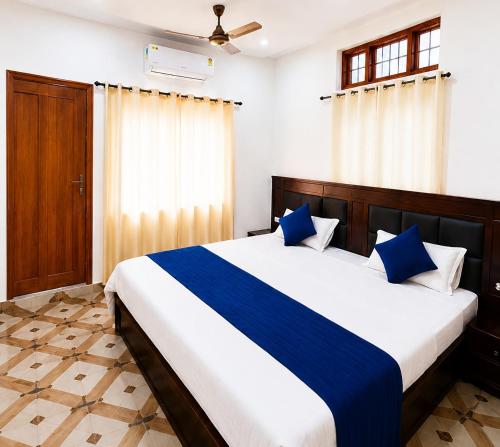 a bedroom with a large bed with blue pillows at Bluemoon Stay in Uttarkāshi