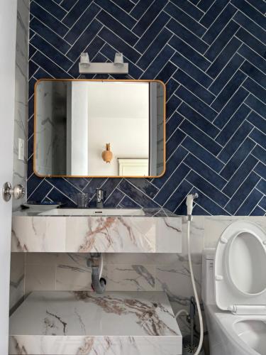 a bathroom with a mirror and a toilet at Lisa House Phu Quoc in Phú Quốc