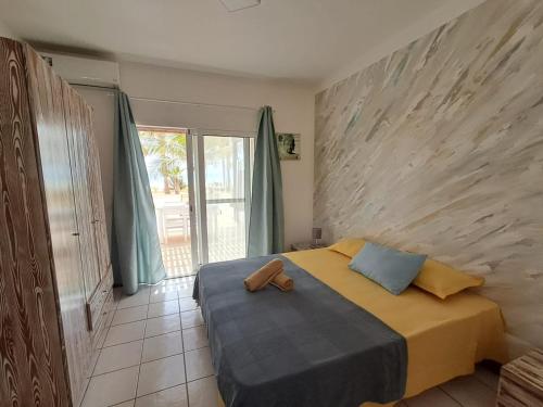 a bedroom with a bed with a stuffed animal on it at Vilas Praia de Chaves SEA VIEW sol y mar in Rabil