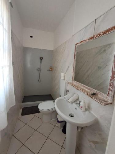 a bathroom with a sink and a toilet and a mirror at Vilas Praia de Chaves SEA VIEW sol y mar in Rabil