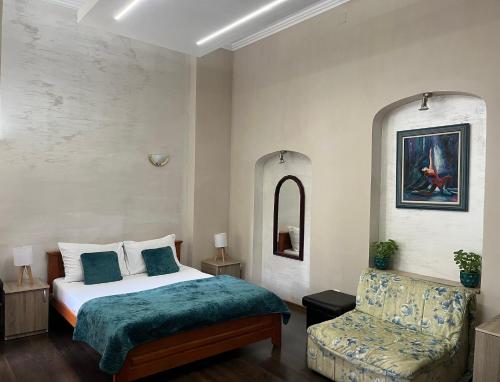 a bedroom with a bed and a chair at Apartments Skadarlija in Belgrade