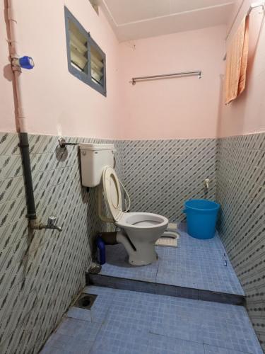 a bathroom with a toilet in a room at Eons riverdale in Kottayam