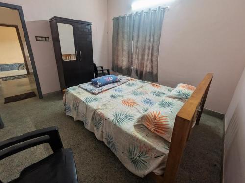 a bedroom with a bed and a mirror at Eons riverdale in Kottayam