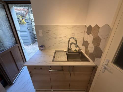 a kitchen with a sink and a counter top at Les Remparts T2 et T3 2 Etoiles in La Roche-Posay