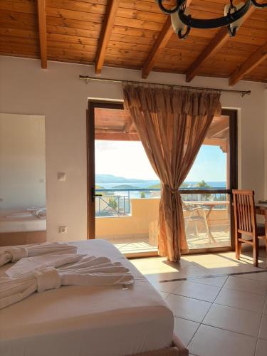 a bedroom with a bed and a large window at Biraci Residence in Ksamil