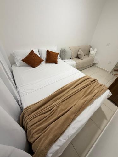 a large bed with a blanket on it in a room at Condomínio Club Resort 2 quartos com ar na melhor da Aruana in Aracaju