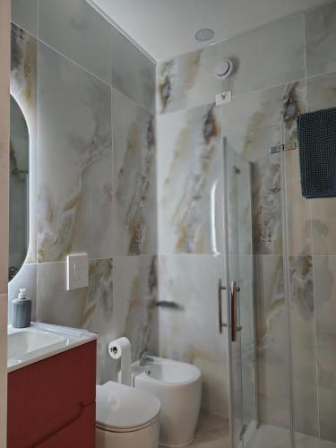 a bathroom with a shower and a toilet and a sink at SEA Studio Flat in Misano Adriatico