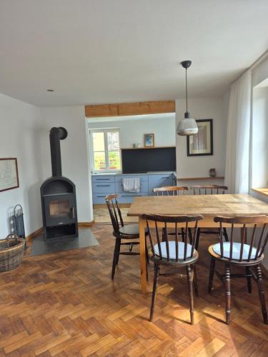 a living room with a wooden table and a wood stove at Bei Jakobus in Künzelsau
