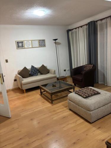 a living room with a couch and a coffee table at Casa El Manantial in Vallenar