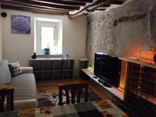 a living room with a couch and a tv at Golden horses in Montebabbio