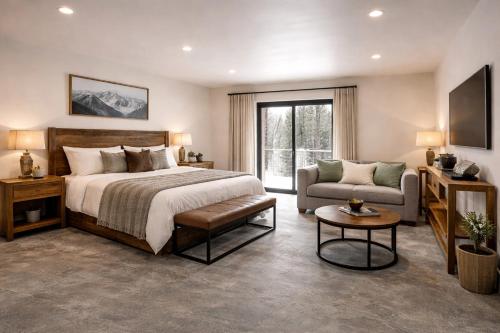 a bedroom with a bed and a couch and a tv at Yellowstone Springs Resort in Island Park