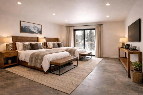 a bedroom with two beds and a large window at Yellowstone Springs Resort in Island Park