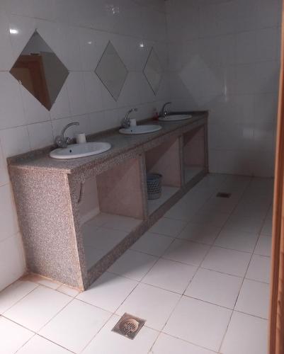 a bathroom with two sinks in a room at Wadi rum Local guide camp in Wadi Rum