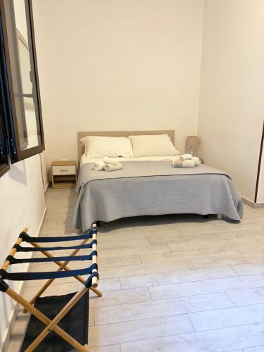 a bedroom with a bed and a wooden floor at Marsala al centro n9 in Marsala
