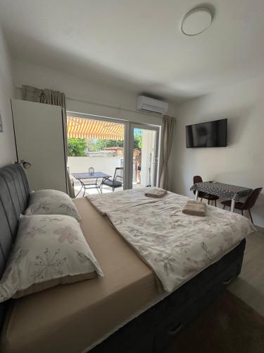 a bedroom with a bed and a view of a patio at Studio apartman Fabi in Novigrad Istria