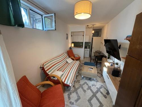 a living room with a couch and a tv at Budva Apartment with Private Parking in Budva