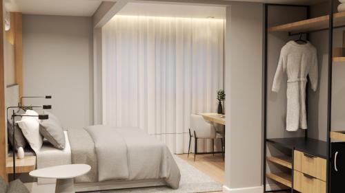 a bedroom with a bed and a table and a window at Hotel Campo Largo Comfort in Campo Largo