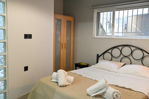a bedroom with two towels on a bed at West of Preveza Luxury Jacuzzi Apartment in Preveza