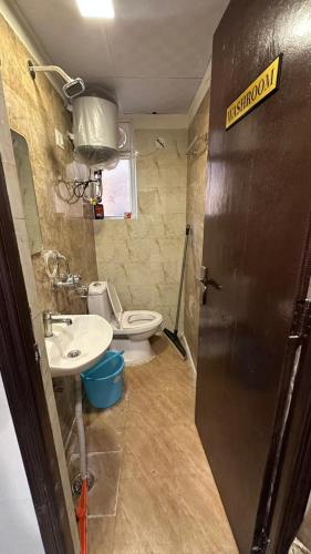 a bathroom with a sink and a toilet in it at THE NEST - Kingdom in Ghaziabad