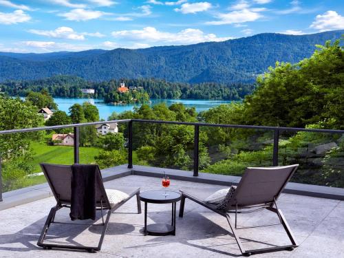 a balcony with two chairs and a table with a view at Vila Katarina - Lake View Apartments in Bled