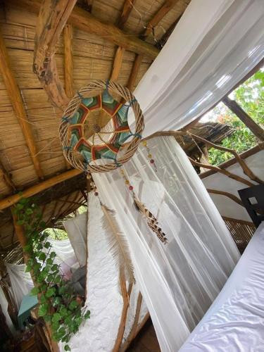 a curtain hanging from a ceiling in a room at Bio Hotel - Eco Glamping El Refugio in Gigante