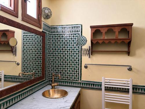 a bathroom with a sink and a mirror at Bright Riad with Panoramic Views - Oudayas in Rabat