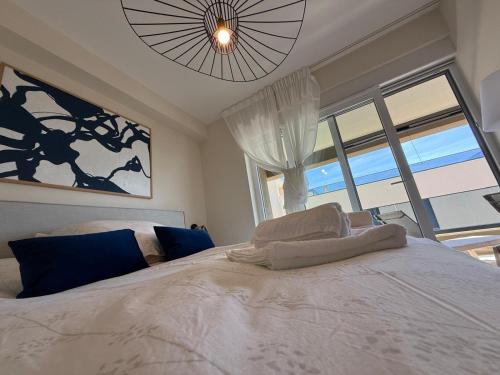 a bedroom with a white bed with a large window at Starview in Privlaka