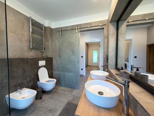 a bathroom with two sinks and two toilets at Black Diamond Apartments in Kobylnice