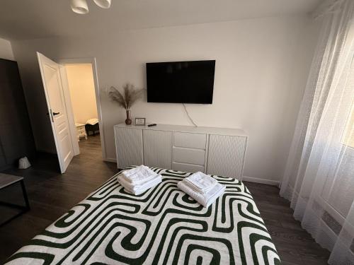 a room with a bed with a flat screen tv at Ventos g 51 Apartment in Mažeikiai