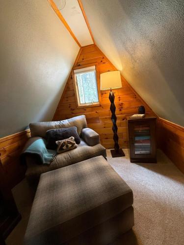 a room with a couch and a lamp in a attic at The Remington House in Woodruff
