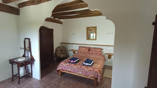 a bedroom with a bed with two books on it at Spacious Country House for 8 near Olot Remote Work & Nature Escape in Olot