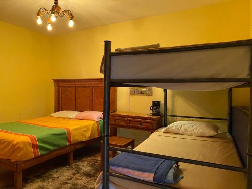 a bedroom with two bunk beds and a desk at Hotel Departamentos Suites in Guanajuato