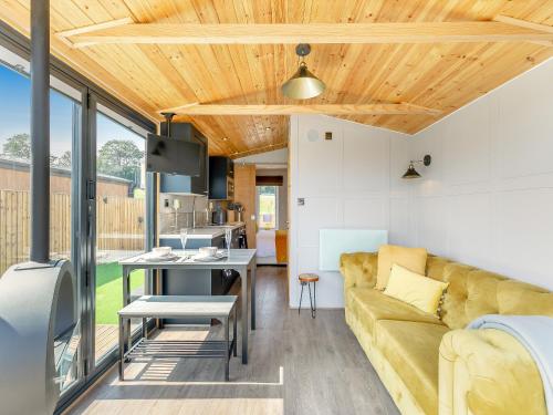 a living room with a couch and a table at Sky Lark Lodge - Uk49904 in Appley Bridge