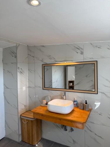 a bathroom with a sink and a mirror at Above the Sea - Sparto in Spartos