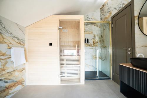 a bathroom with a walk in shower next to a toilet at Boutique Hotel Solterra - Crikvenica in Crikvenica