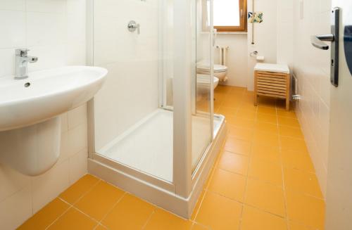 a bathroom with a shower and a sink and a toilet at Residence Baia degli Sciti in Torre a Mare