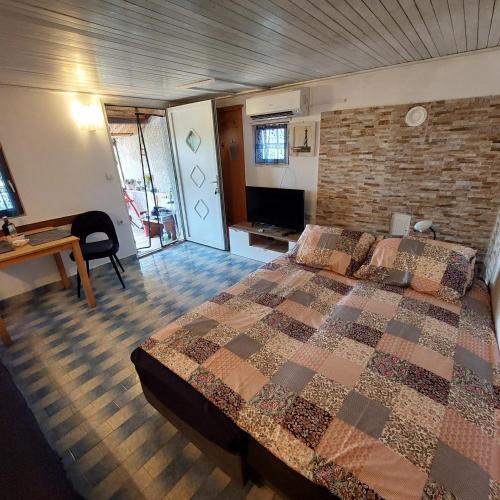 a bedroom with a bed and a brick wall at Holiday house in Pula
