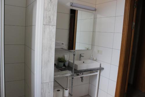a bathroom with a sink and a mirror at Strong Five apartment in Sumy