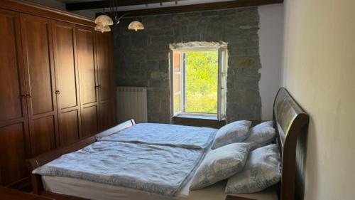 a bed in a bedroom with a window at Pr' Tekcu in Dekani