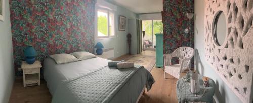 a bedroom with a bed and a tub in it at La Nomade in Andernos-les-Bains