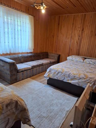 a living room with two beds and a couch at Simal Apart Ev in Ayder Yaylasi