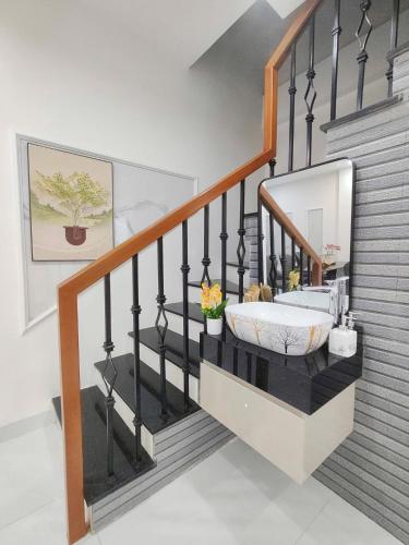 a bedroom with a staircase with a mirror at Vinh House Homestay in Thôn Trường Giang