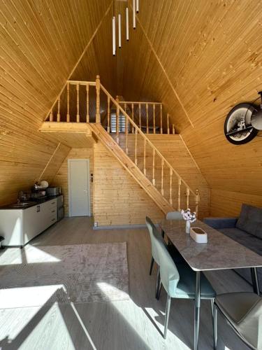 a living room with a table and a staircase at Tosor Medet A-frame in Tossor