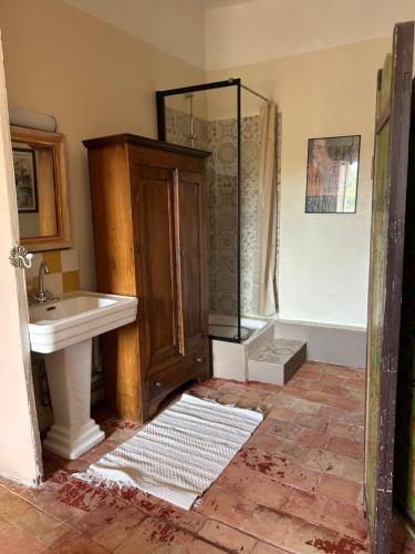 a bathroom with a sink and a shower at Chambre in Riez