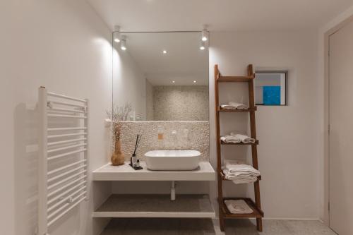 a bathroom with a sink and a mirror at Villa Ammos with Private Pool, Sauna & Seaview in Gialova