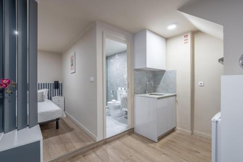 a bathroom with a sink and a toilet in a room at CasAmalia 54 in Viana do Castelo